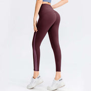 Rear view of a woman in burgundy butt lifting workout leggings, showcasing comfort and a flattering fit for activewear.