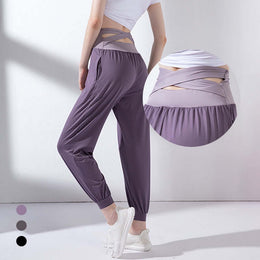 High waist purple yoga pants with cross-hollow design and breathable fabric for comfort and style.