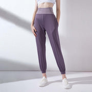 High waist purple yoga pants with elastic cuffs and a fitted style, ideal for workouts and casual wear.
