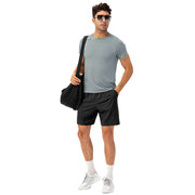 Man wearing a loose fit quick-dry running t-shirt, shorts, and sunglasses, ready for workout.