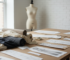 Fabric rolls, garment patterns and design sketches on a studio table for custom apparel manufacturing