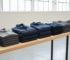 Stacked polo shirts, jackets and hoodies for bulk custom company workwear