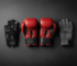 Boxing, cycling and winter sports gloves arranged together on a dark surface